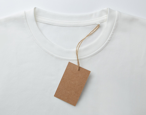 Brown price tag on white T-shirt