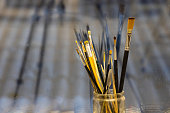 Paint brushes in glass jar