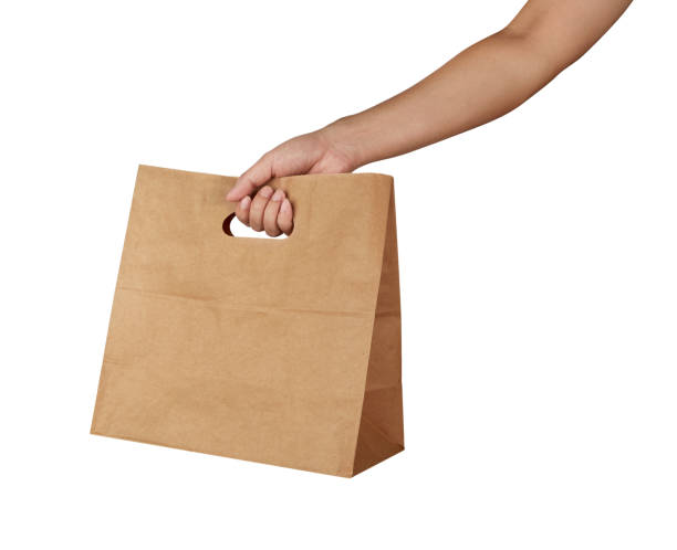 istock Hand holding a brown paper bag with handle isolated on white background 1727743973