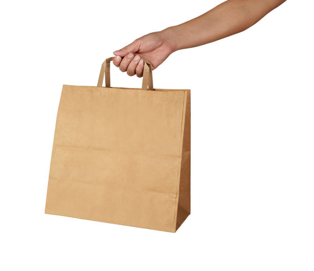 istock Hand holding a brown paper bag with handle isolated on white background 1727744005