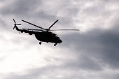 Silhouette of Soviet helicopter Mi-8 common operational military aircraft aloft in the air