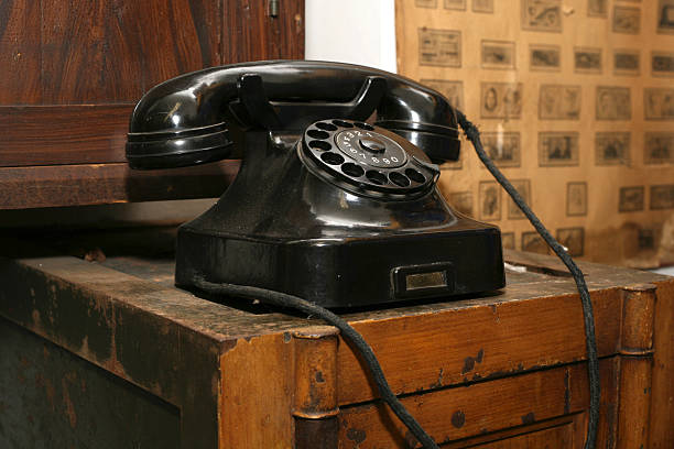 An antique telephone on a wooden table