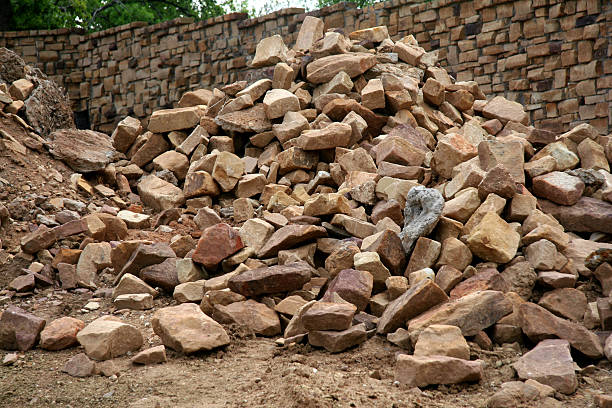 Building a Wall Rocks used for building a residential community wall. brown bricks stock pictures, royalty-free photos & images
