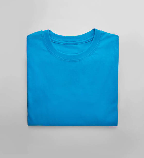 Blue folded t-shirt with on white background stock photo