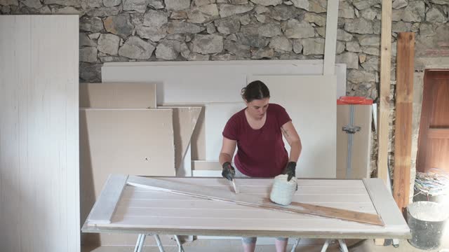 Carpenter woman crafting a barn door