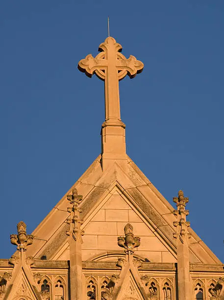 The picture depicts the cross that sits atop the Washington National Cathedral.  The picture was taken just before sunset on a clear day.  The uniform sky and lighting gave an effect that looked like the top of the building pasted onto blue paper.