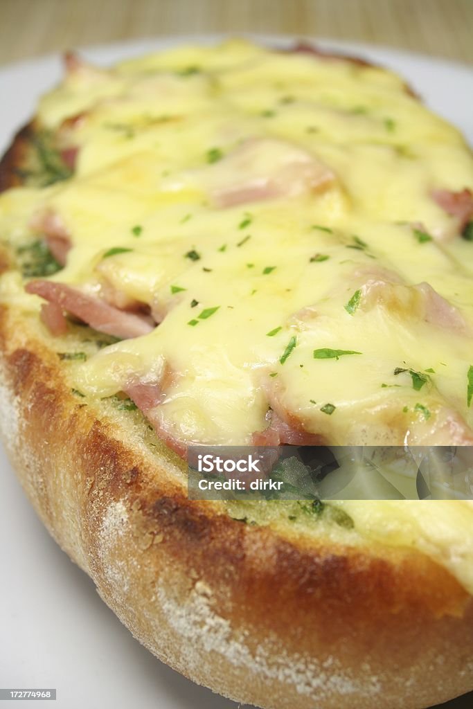 French Bread Pizza "Baguette canape, scolloped with ham and cheese, homemade garlic-herb butter as spread and topping" Baguette Stock Photo
