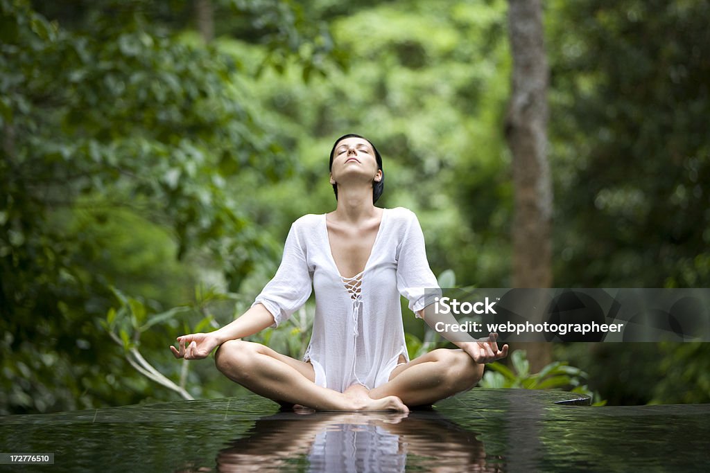 Yoga style Woman in white doing yoga by infinity pool, blurred, space for copy, canon 1Ds mark III Yoga Stock Photo