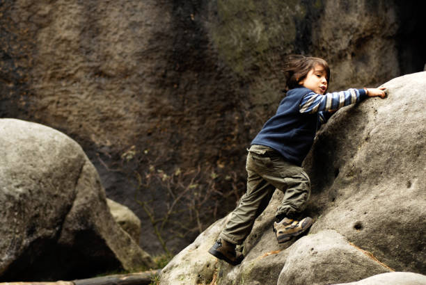 istock young boy climbing in rocks 172777927