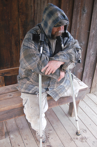 Poor disabled man sits alone in desperation.PLEASE SEE MY OTHER HOMELESS PHOTOS