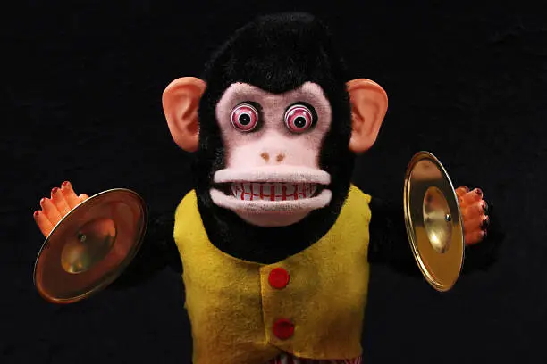 1950's retro Cymbal-Playing Monkey in a dark bedroom.