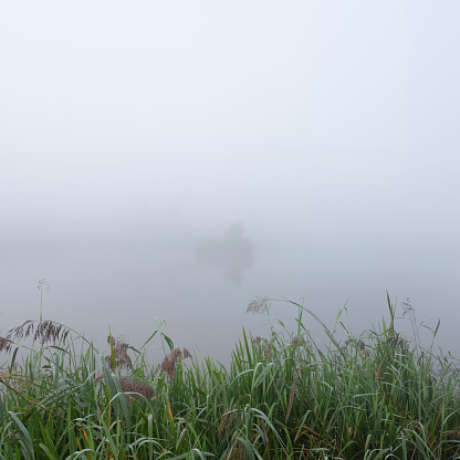 View of Ban Wat Chan reservoir with mountains and mist in the morning at Chiang Mai, Thailand