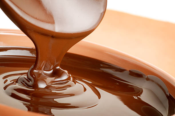 Chocolate Chocolate being poured into a container milk chocolate stock pictures, royalty-free photos & images