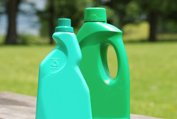 Woman filling a diesel engine ad blue fluid from canister. Diesel exhaust fluid for reduction of air pollution.