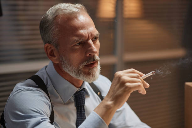 istock Ambient senior detective studying case in office and smoking 1727804887