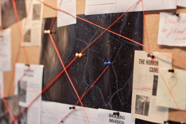 istock Closeup evidence board with red thread connecting map and pictures 1727804922