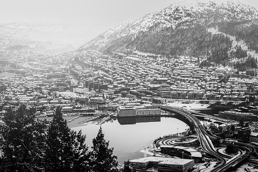 view from the mountains to Bergen in the winter with roads , Norway. Photo in black and white