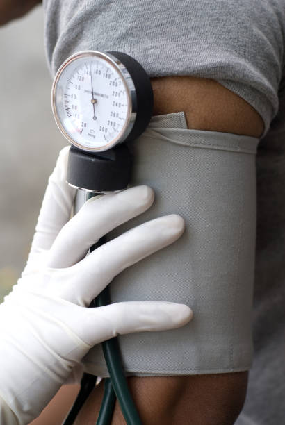Health professional checking blood pressure with sphygmomanometer
