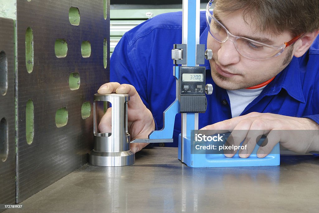 Quality control Control of the dimensions of a machine part with a caliper. Many other  machining pictures are in this LB: Accuracy Stock Photo