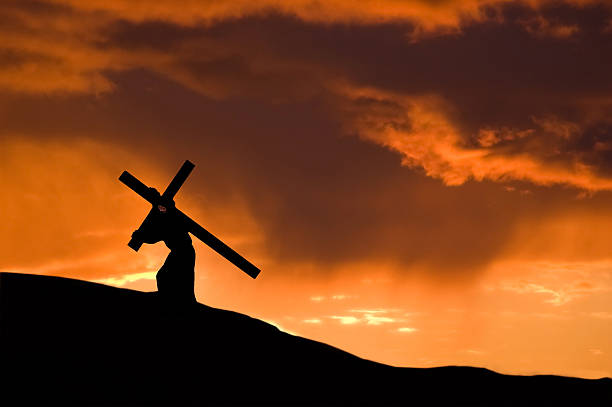 istock Christ Carrying the Cross With an Orange Sunset 172782525