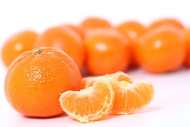 Tangerines and clementine wholes and slices on white stock photo