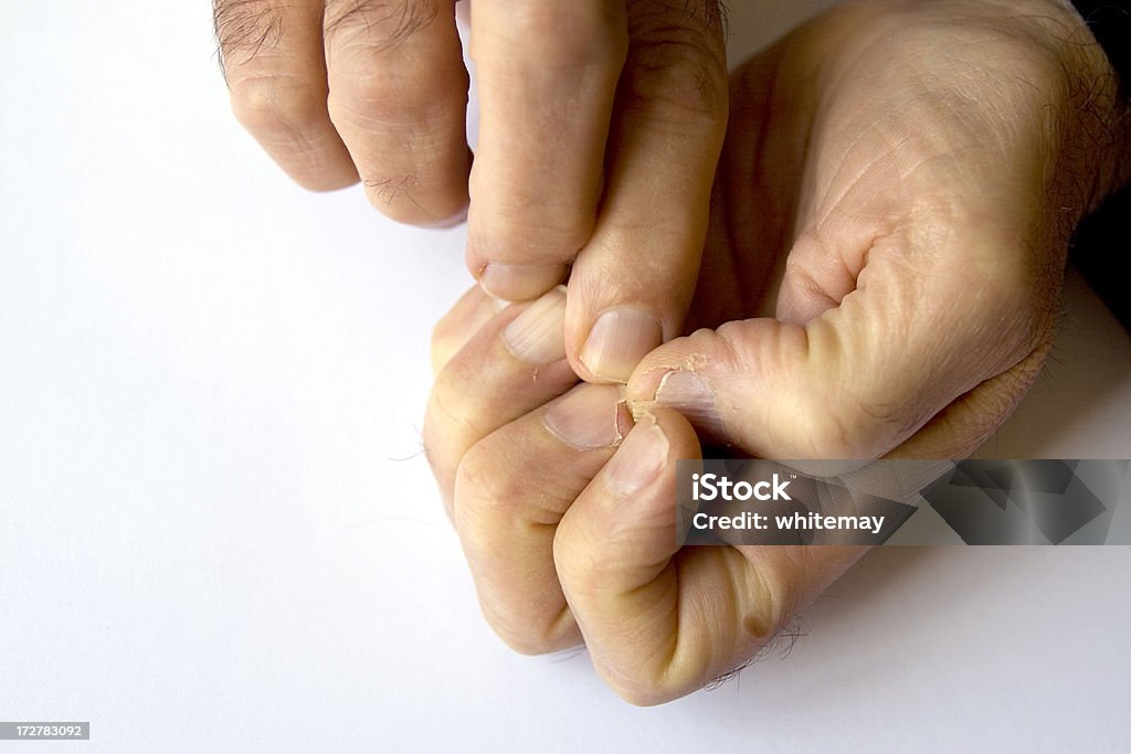 Nail picker A man picking at his already-damaged fingernails.[/url] Fingernail Stock Photo