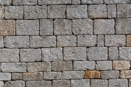 Architecture textures, detailed view of a traditional paired granite masonry, used on a old walls...