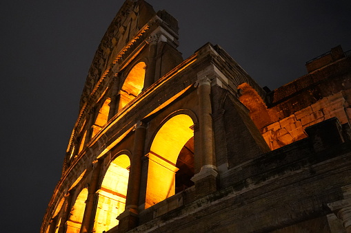 The iconic arches of the Colosseum captured from the side