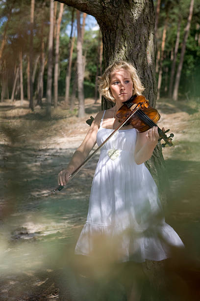 istock Young woman playing her violin outdoor 172784457