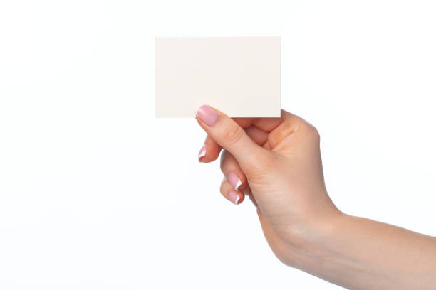 istock Female hand with blank white business card isolated on white 1727848182