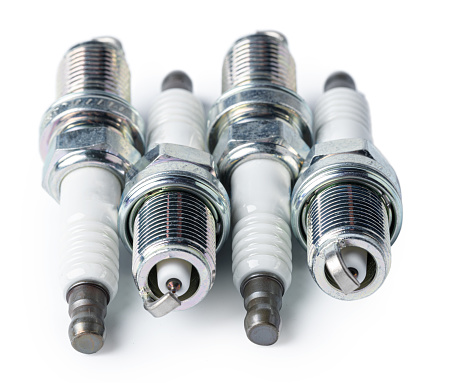 Car part. Spark plugs isolated on white. Close up.