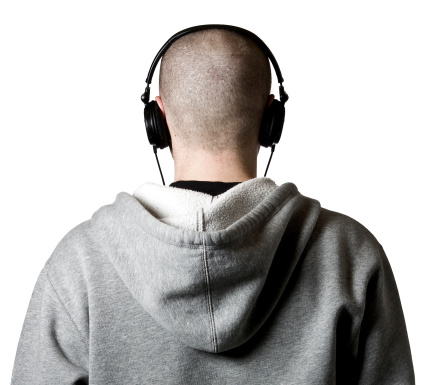 Teen/young adult wearing headphones and hoody.