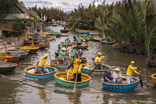 Hoi An – Cam Tanh, Vietnam - November 07, 2022: tourists round boat tour on river in palm forest neat Hoi An, Vietnam