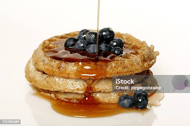 Pouring Syrup On Blueberry Waffles Stock Photo - Download Image Now - Syrup, Waffle, Berry Fruit