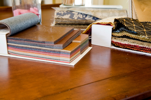Fabric and leather swatches in an interior design studio.