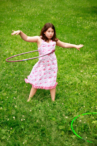 istock Little girl playing with hula-hoop 172785979