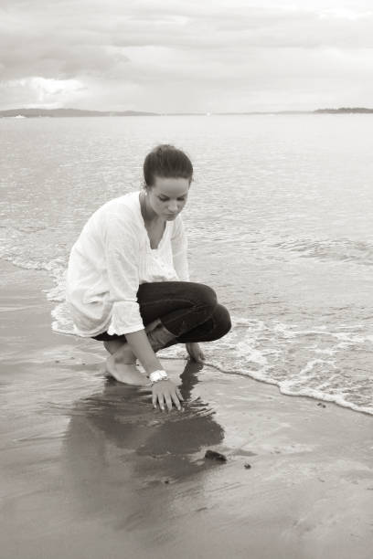 istock Girl drawing in the sand 172785984