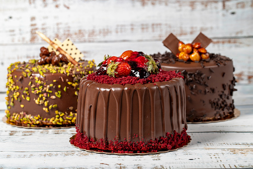 Varieties of chocolate cake. Various birthday cakes on wooden background. patisserie products. Close up