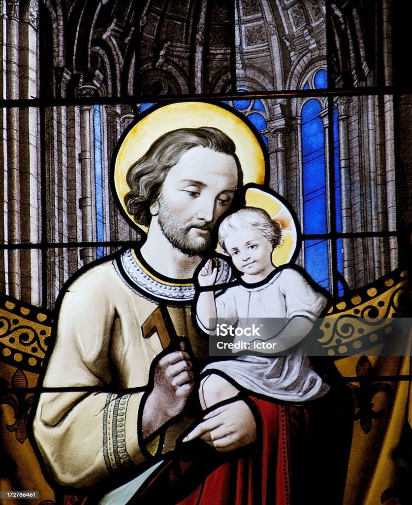 Baby Jesus and his father Joseph Stained glass window detail from the st. nicolas church in Amsterdam showing Baby Jesus and his father Joseph. Given to the church in 1886 by A.J. Naber and pastor J.H. van Born. Made in France and possibly designed by the then 18 year old Jan Coenraad Bleijs (1868-1952) Joseph - Husband of Mary Stock Photo