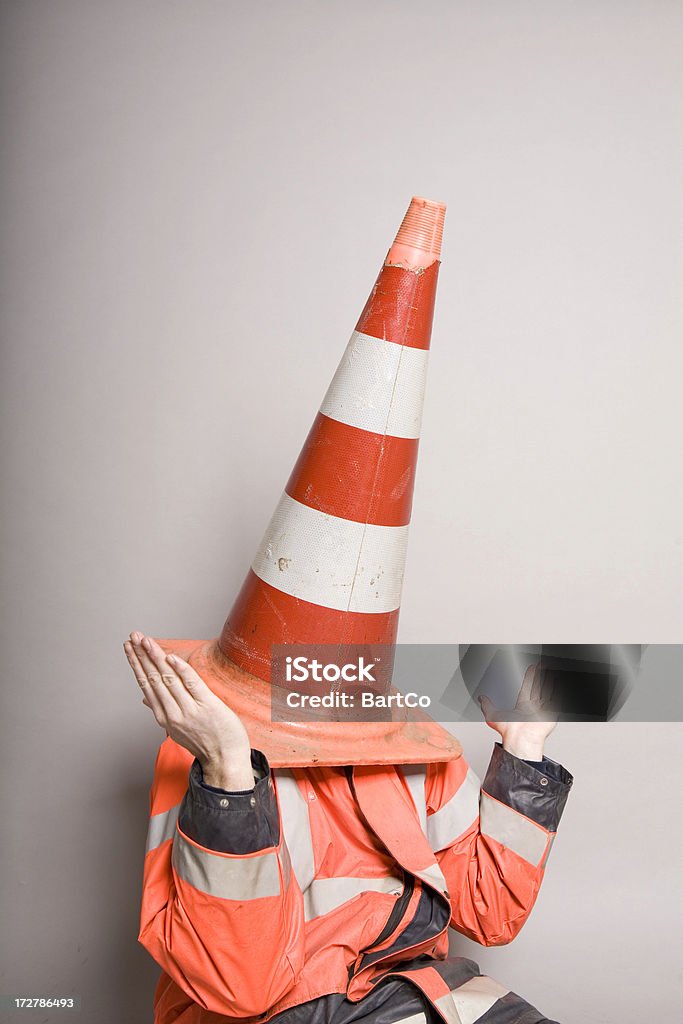 traffic cone over head, don't know This man doesn't know what to do Adult Stock Photo