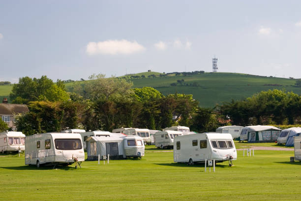 istock Several white caravans parked on green field 172786776