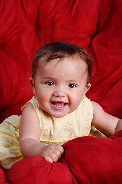 istock Baby girl on red couch 172787010