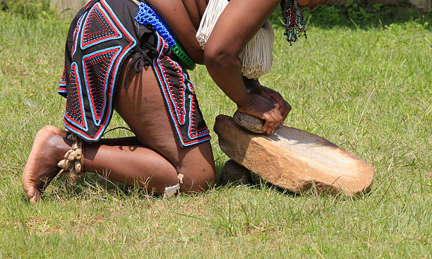 istock Zulu woman grinding maize 172787570