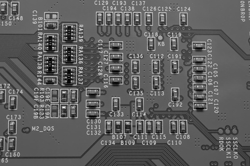 Electronic components on a printed circuit board - chips and capacitors
