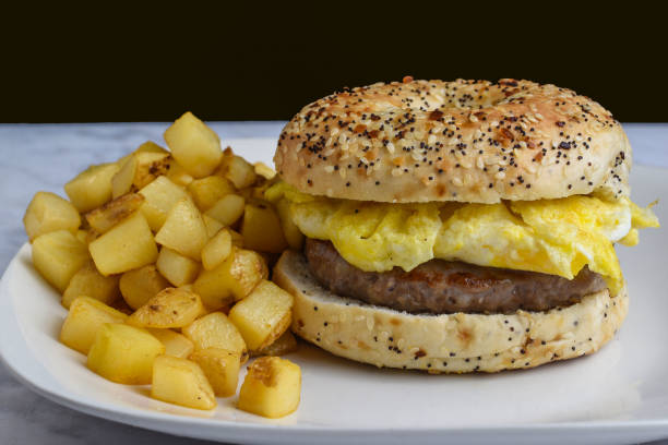 istock scramble egg  and sausage on a everything bagel 1727883501