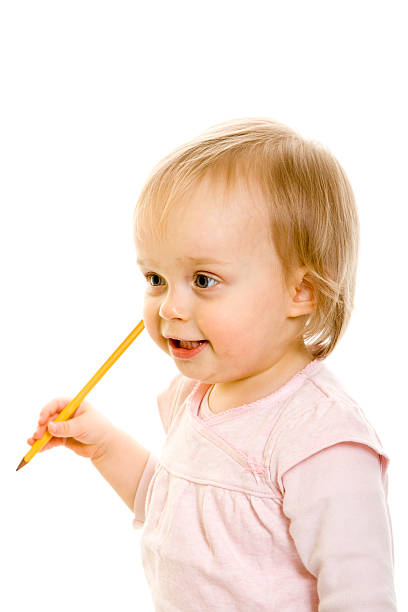 Small girl with a pencil isolated on white stock photo