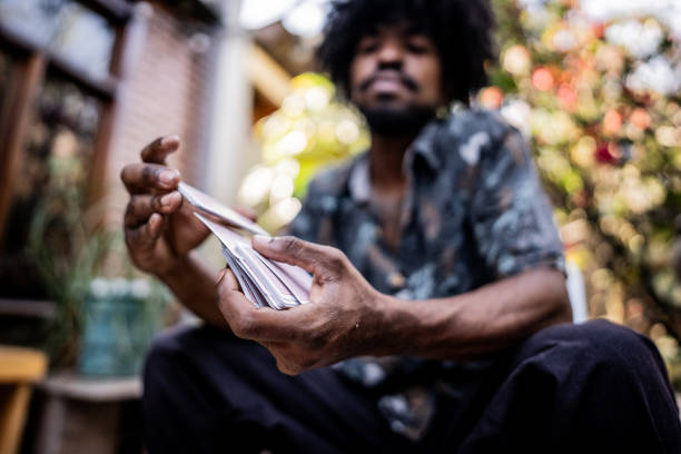 Young man shuffling cards at home