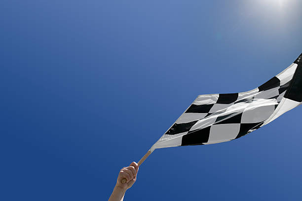 istock Checkered flag waving against blue sky 172789807