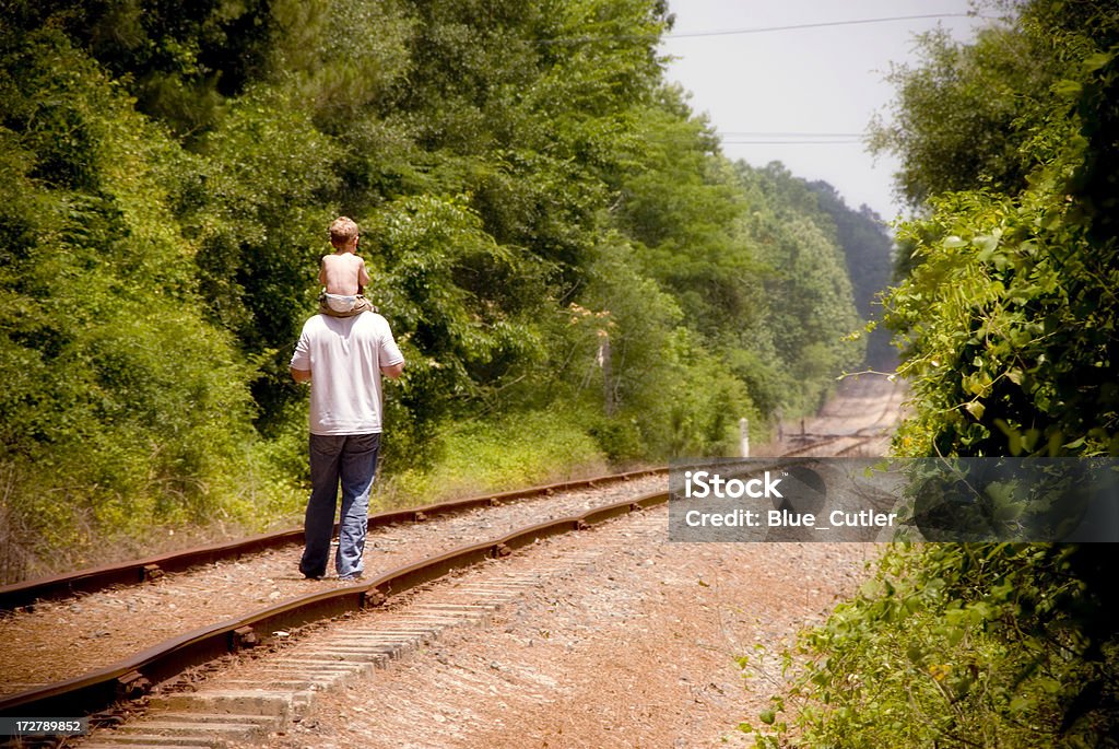 Father and Son Walking Walking down the train tracks. Exploration Stock Photo