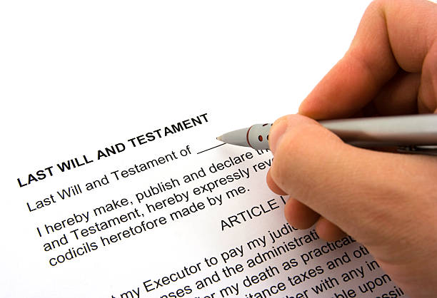 istock Person Signing a Will and Testament Form 172790156